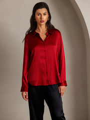 Women's mulberry silk long sleeve lapel collar shirt in deep red, button-up design, paired with black pants.