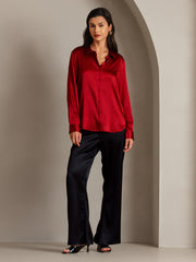 Women's mulberry silk long sleeve lapel collar shirt in vibrant red, paired with black silk pants.