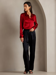 Women's 19Momme mulberry silk long sleeve lapel collar shirt in red, paired with black silk pants.
