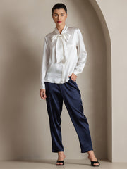 White 19Momme mulberry silk long sleeve tie neck blouse with navy silk pants.
