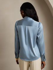Women's light blue mulberry silk long sleeve tie neck blouse with subtle pleats.
