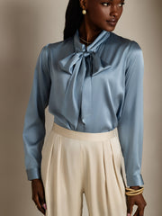 Women's blue mulberry silk long sleeve tie neck blouse with elegant bow detail.
