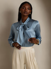 Women's light blue mulberry silk long sleeve tie neck blouse with a satin finish.