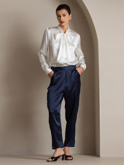 White 19Momme mulberry silk long sleeve tie neck blouse with navy satin trousers.