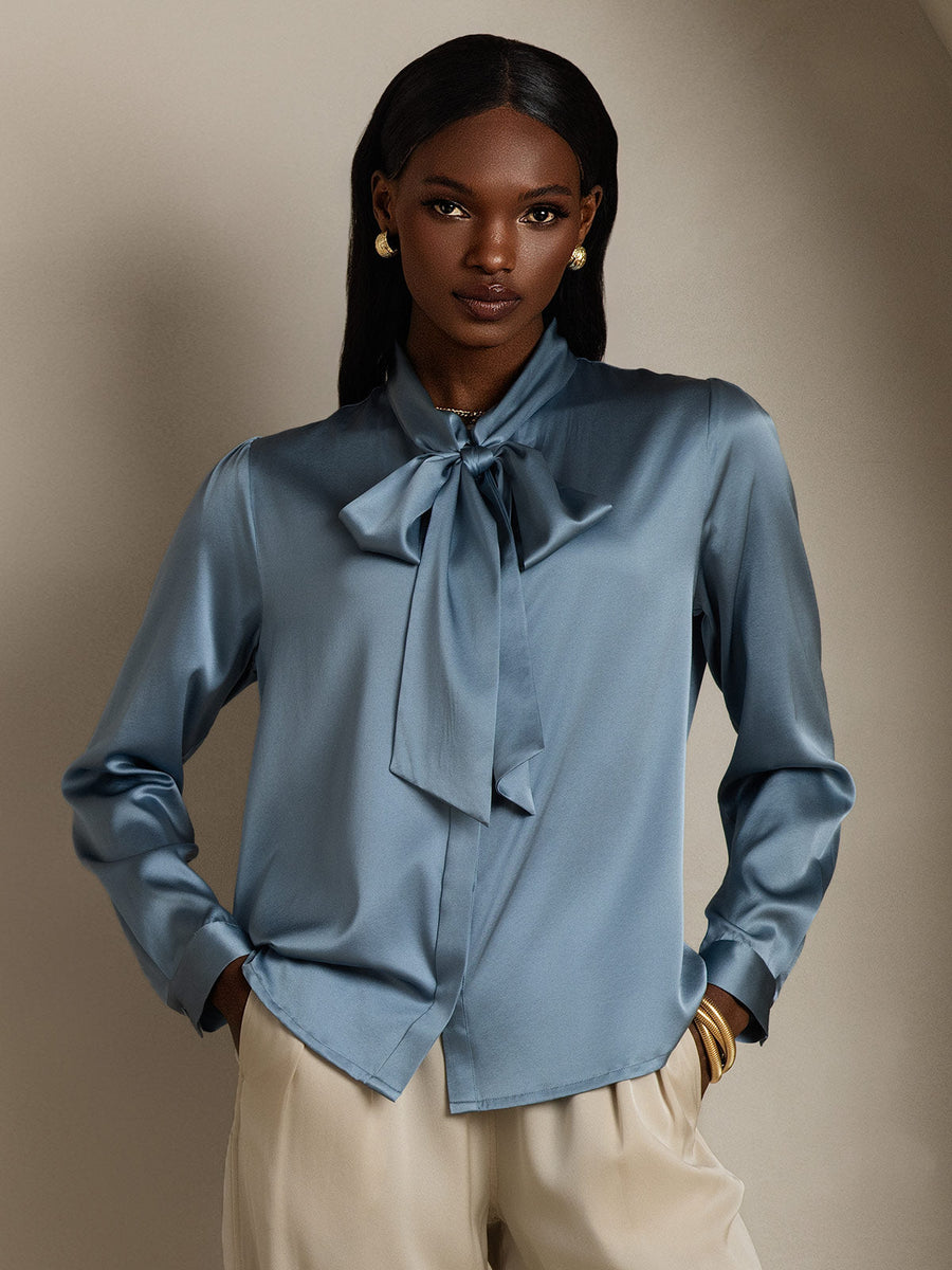 Grayish blue 19Momme mulberry silk long sleeve tie neck blouse on a model.