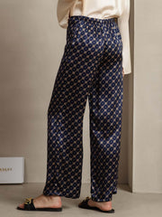 Navy 19Momme mulberry silk wide-leg women's pants with chain print and side pockets.