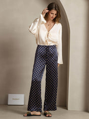 Women's 19Momme mulberry silk navy chain print wide-leg pants with side pockets, paired with a cream silk top.