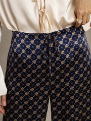 Women's 19 Momme mulberry silk navy chain print wide-leg pants with side pockets and drawstring waist.