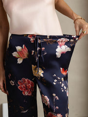 Navy floral print wide leg women's mulberry silk pants with side pockets and a drawstring waist.