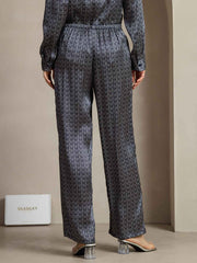Women's navy mulberry silk wide-leg pants with ginkgo print and side pockets.