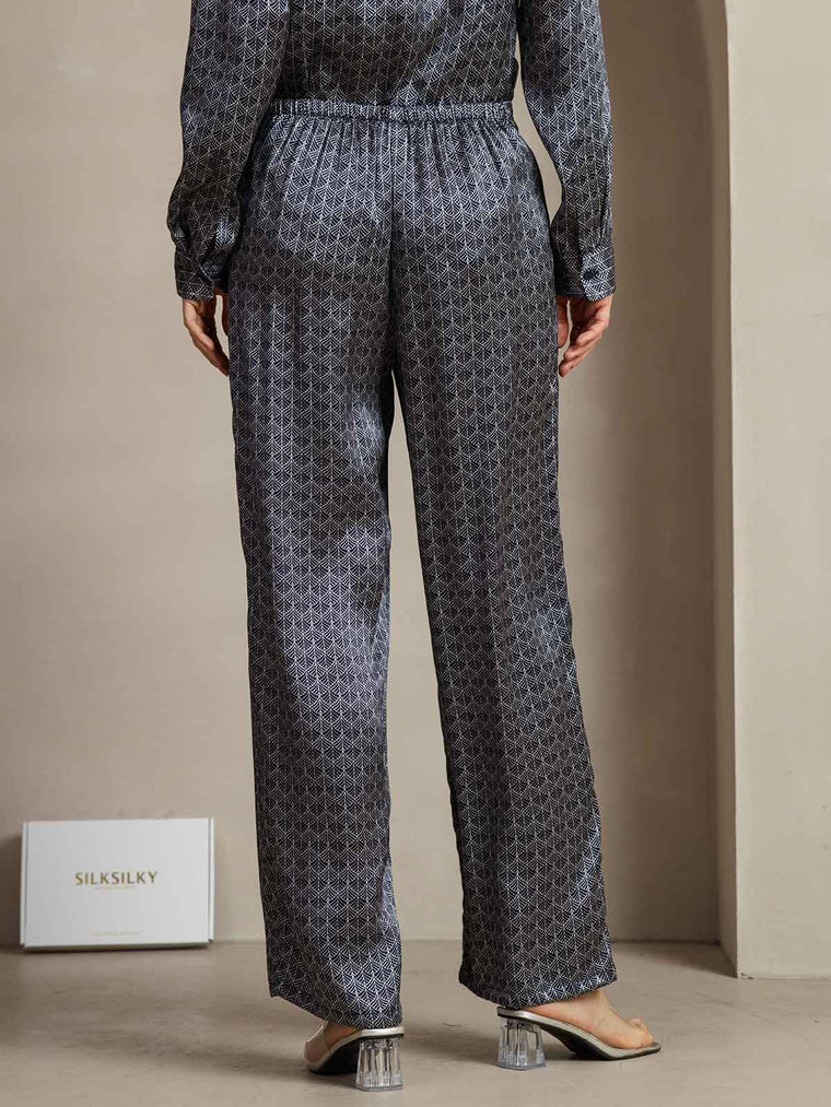 Women's navy mulberry silk wide-leg pants with ginkgo print and side pockets.
