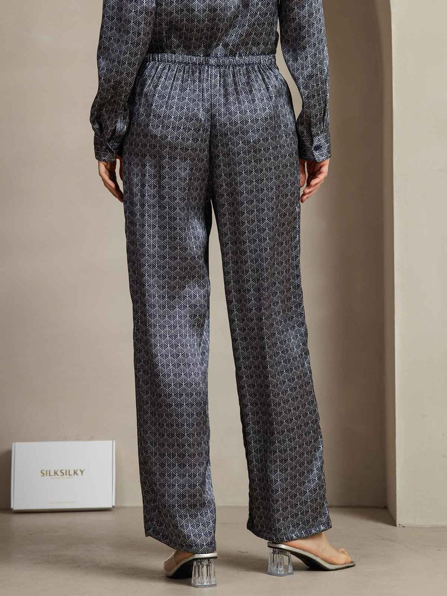 Women's navy mulberry silk wide-leg pants with ginkgo print and side pockets.