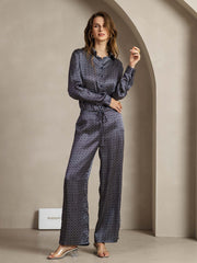 Women's navy mulberry silk wide-leg pants with ginkgo print and side pockets, paired with a matching long-sleeve top.
