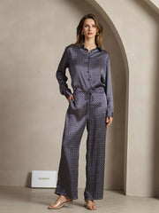 Women's navy mulberry silk wide-leg pants with ginkgo print, side pockets, and matching long-sleeve shirt.