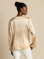Women's relaxed long sleeve mulberry silk top in champagne, with a smooth, luxurious finish.