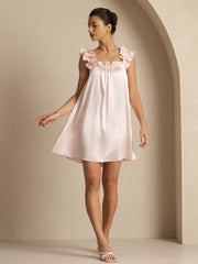 Pink mulberry silk babydoll nightgown with ruffle straps and square neck, worn by a woman.