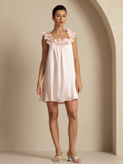 Pink mulberry silk babydoll nightgown with ruffle straps and square neck, worn by a woman.
