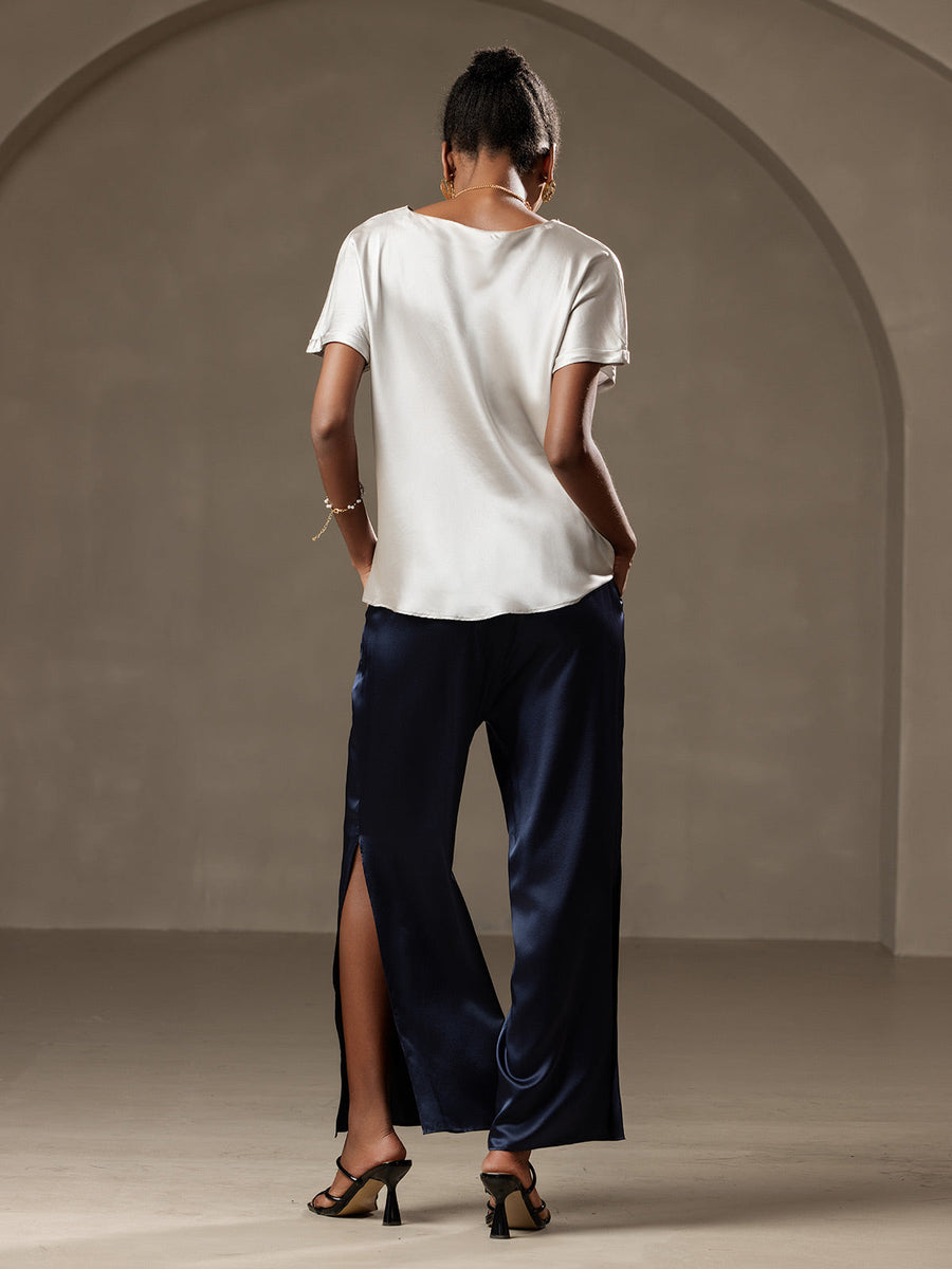 Women's white 19 Momme mulberry silk short sleeve boat neck t-shirt with navy wide-leg pants.