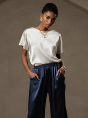 Women's 19 Momme mulberry silk short sleeve boat neck t-shirt in white, paired with navy silk pants.
