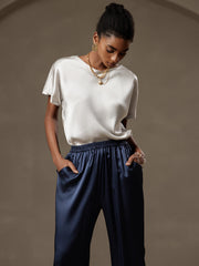 Women's 19 Momme mulberry silk short sleeve boat neck t-shirt in white, paired with navy silk pants.