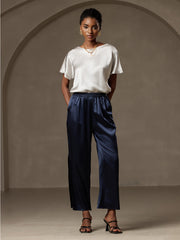 Women's white 19 Momme mulberry silk boat neck short sleeve T-shirt with navy silk pants.