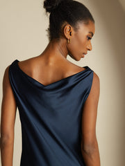 Navy 19Momme mulberry silk sleeveless cowl neck knee dress on a woman.