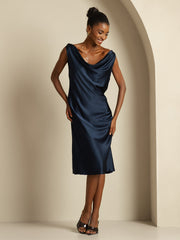 Dark blue mulberry silk sleeveless cowl neck knee dress on a smiling model.