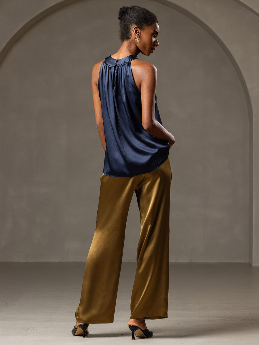Women's navy 19 Momme mulberry silk sleeveless halter neck top with gold wide-leg pants.
