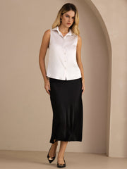 Women's white mulberry silk sleeveless lapel collar shirt with button-up design, paired with a black skirt.