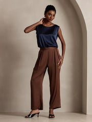 Navy 19Momme mulberry silk sleeveless round neck tank top for women, paired with brown wide-leg pants.