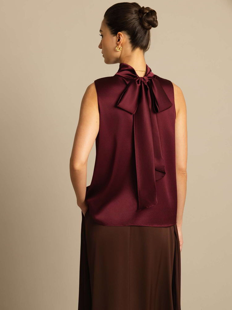 Women's mulberry silk sleeveless tie-neck blouse in rich burgundy, featuring a large bow detail on the back.