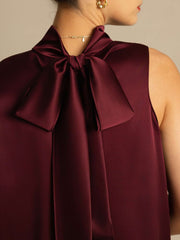 Maroon mulberry silk sleeveless tie-neck blouse with a large bow detail on the back.