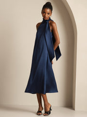 Navy 19 Momme mulberry silk sleeveless midi dress with a tie neck, worn by a woman.