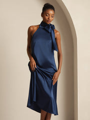 Navy mulberry silk sleeveless tie-neck midi dress on a woman.