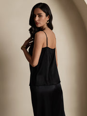 Woman wearing a black 19Momme mulberry silk spaghetti strap camisole.