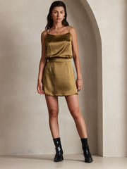 Women's olive green mulberry silk spaghetti strap camisole and matching mini skirt with black boots.