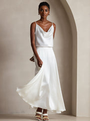 White mulberry silk spaghetti strap cowl neck camisole top and matching skirt on a model.