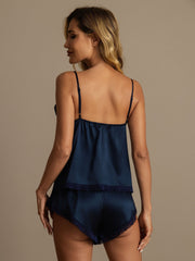Women's navy mulberry silk camisole and shorts set with lace trim, seen from behind.