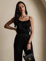 Black mulberry silk spaghetti strap camisole and matching pants on a woman.