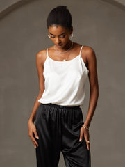 White 19Momme mulberry silk spaghetti strap camisole with round neck, paired with black silk pants.